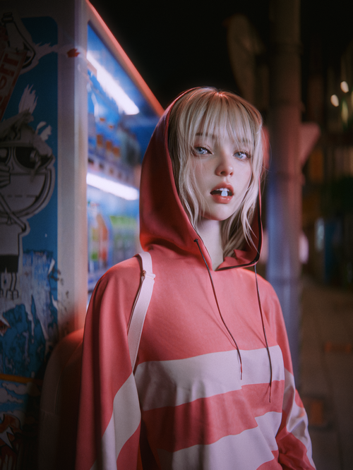 Woman with blonde hair in a pink hoodie at night
