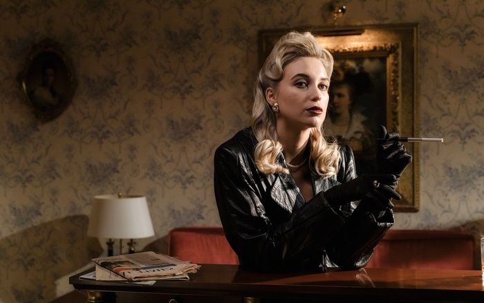 Woman in leather jacket smoking a cigarette