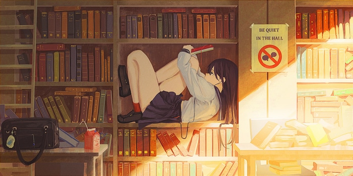 Schoolgirl reading a book in a library shelf