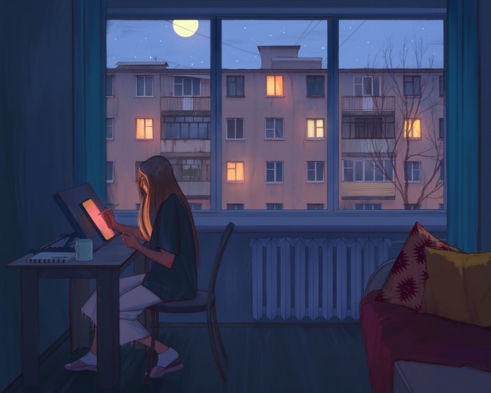Woman drawing on a tablet by the window at night