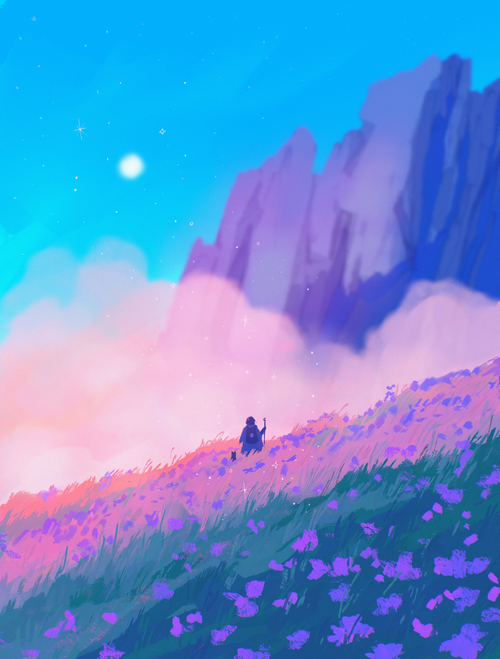 Person sitting in a field of purple flowers with mountains in the background