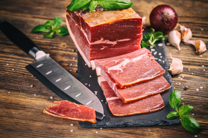 4K food: cured meat, knife, onion, garlic, and basil