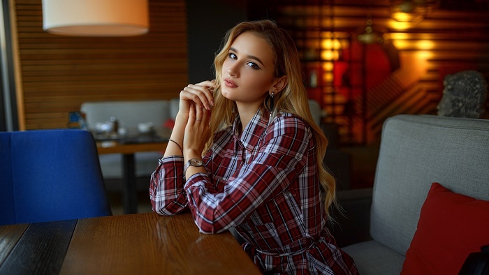 Woman with blonde hair in a plaid shirt