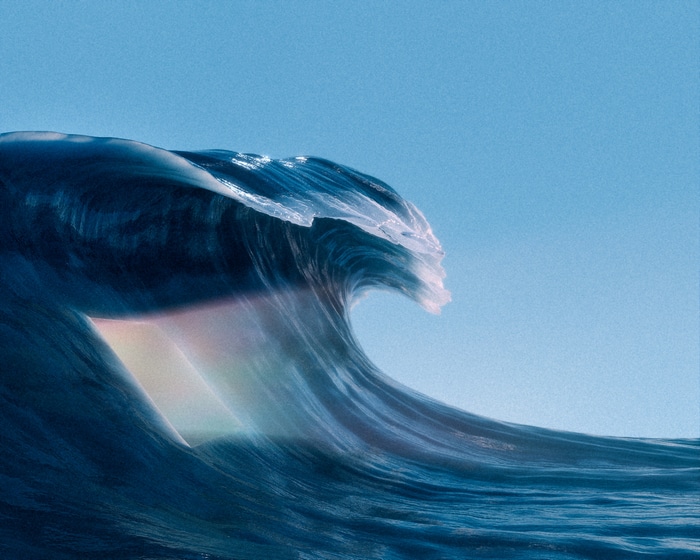 A large wave with a rainbow effect