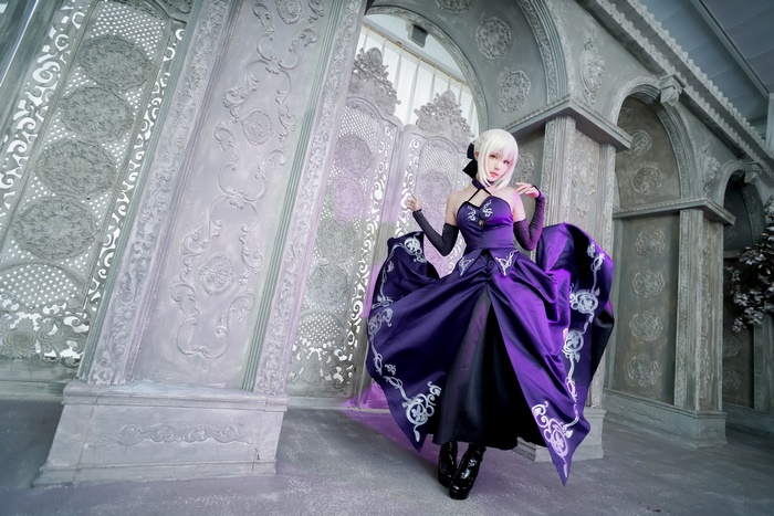Woman in purple dress with white hair