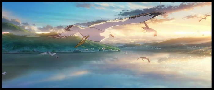 Suzume birds flying over a lake at sunset