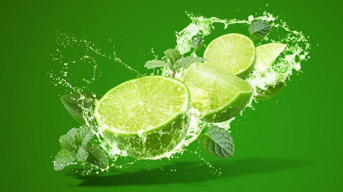 Lime slices with mint leaves and water splashes