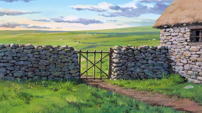 Stone fence and gate in a grassy field