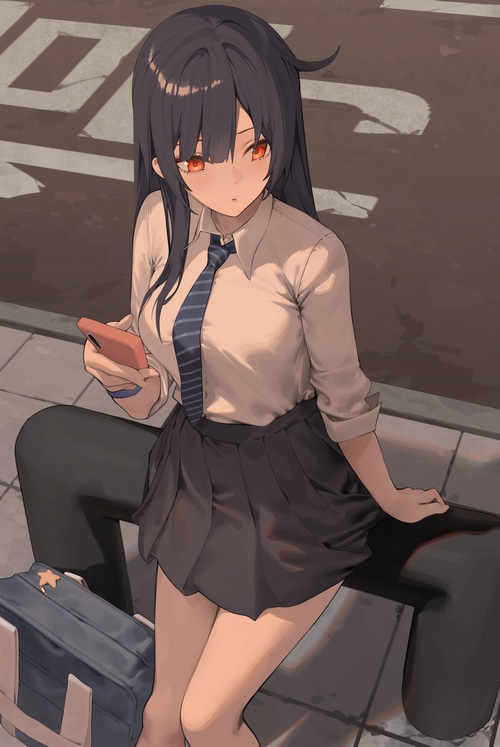 Schoolgirl with phone and school uniform