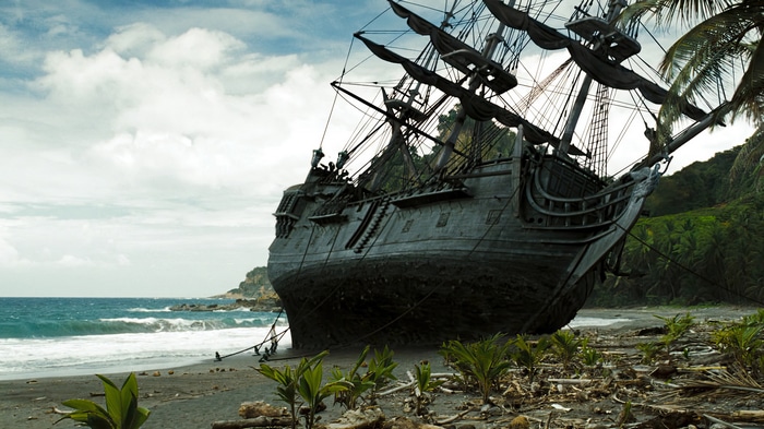 The Black Pearl ship grounded on a tropical beach