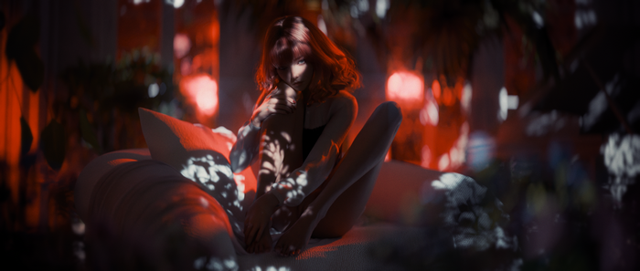 Woman with red hair sitting on a bed with shadows