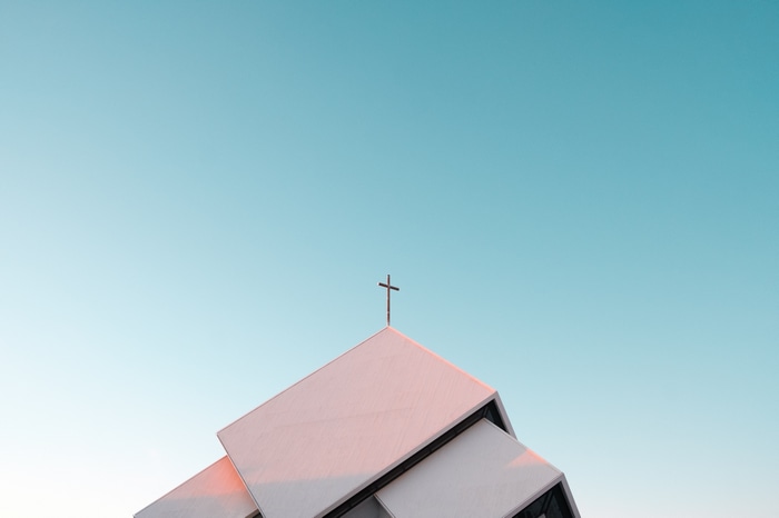 Cross on a modern building against a clear sky
