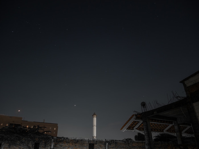 Night sky over Indonesia with stars and buildings