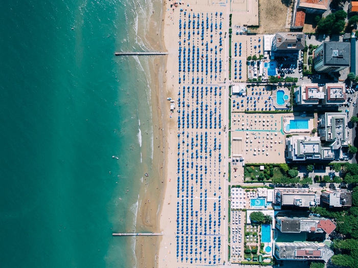 Aerial view of Lido di Jesolo beach with umbrellas and swimming pools