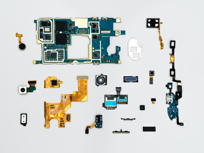 Disassembled Smartphone Components on White Background