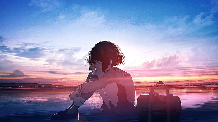 Girl in school uniform sitting by the water at sunset