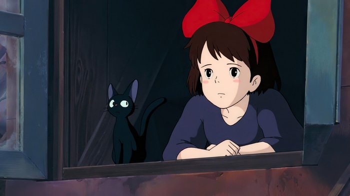 Kiki and Jiji looking out a window