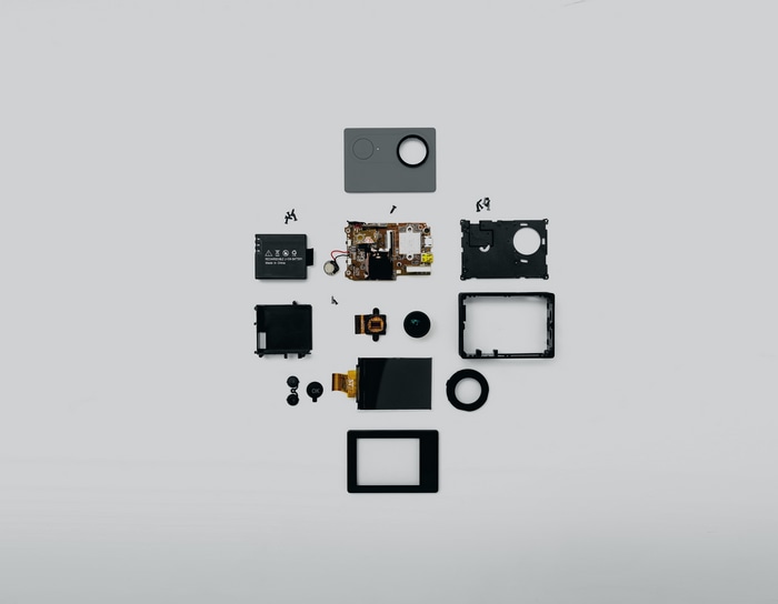 Disassembled action camera components laid out flat