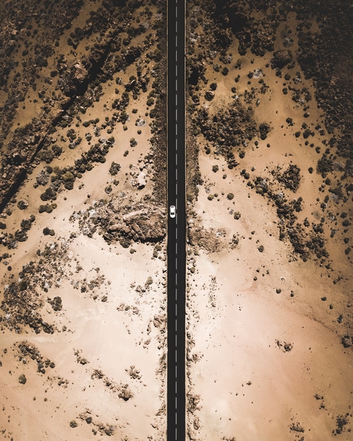 Aerial view of a car on a desert road