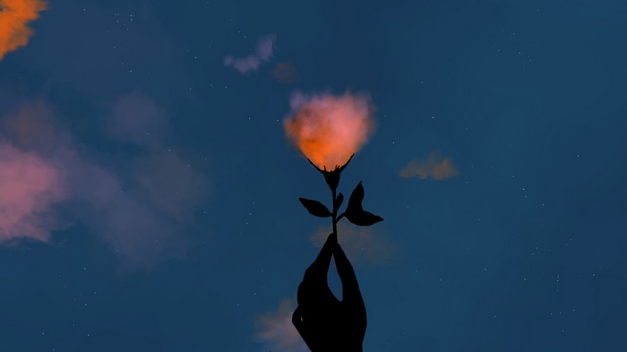 Silhouette of a hand holding a flower with a fiery cloud