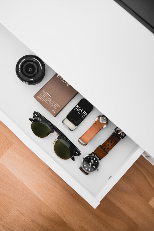 Flat lay of men's accessories in a drawer