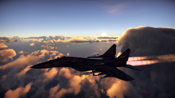 Mikoyan MiG-29 jet fighter flying through clouds at sunset