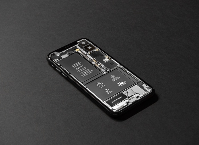 iPhone disassembled showing internal components and battery