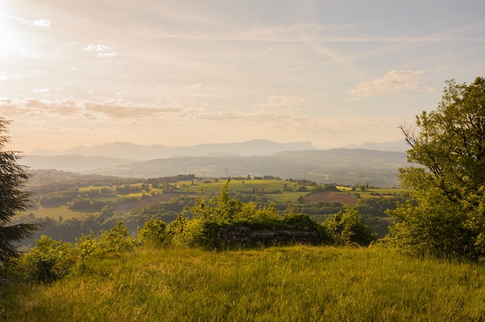 Rolling hills and distant mountains at sunset
