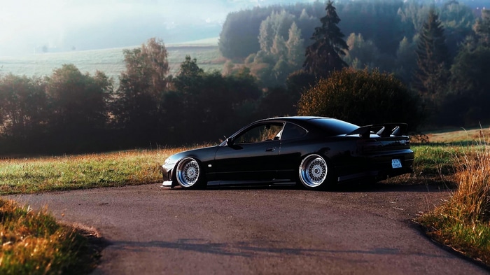 Black Nissan Silvia S15 stanced on a road