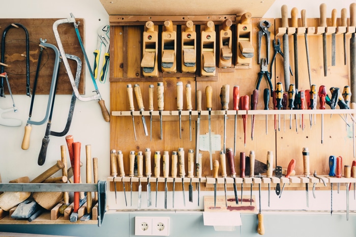Organized workshop with carpentry tools on the wall