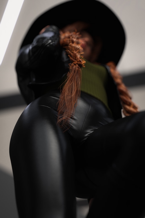 Woman in hat and leather pants, bottom view