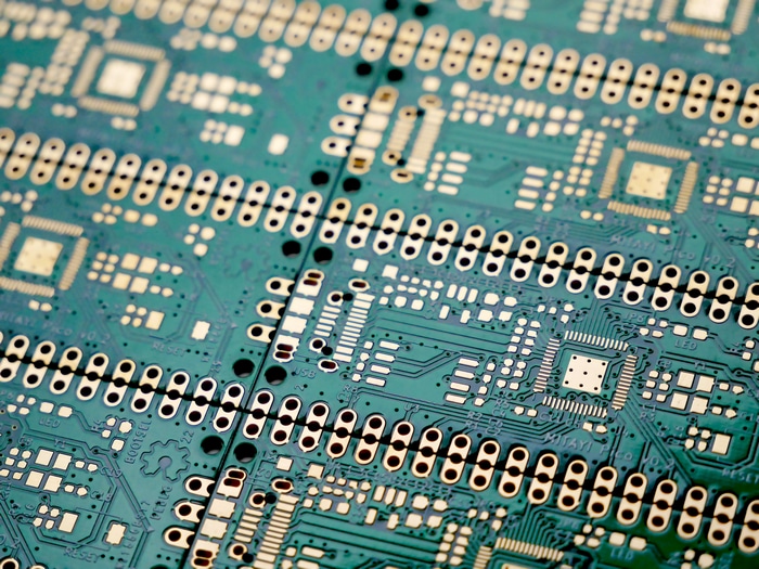 Close-up of a green circuit board with gold connectors