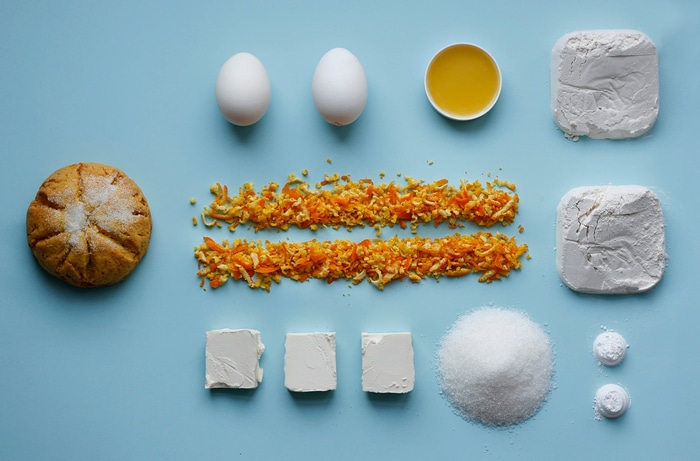 Baking ingredients laid out on a blue surface