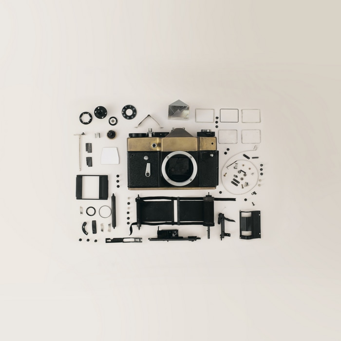 Disassembled vintage camera with parts laid out
