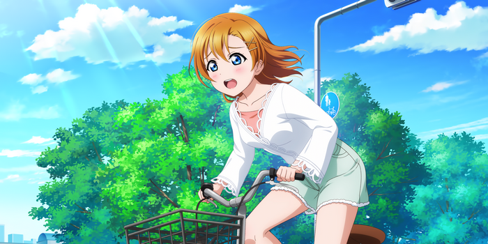 Honoka Kousaka riding a bicycle under the sun