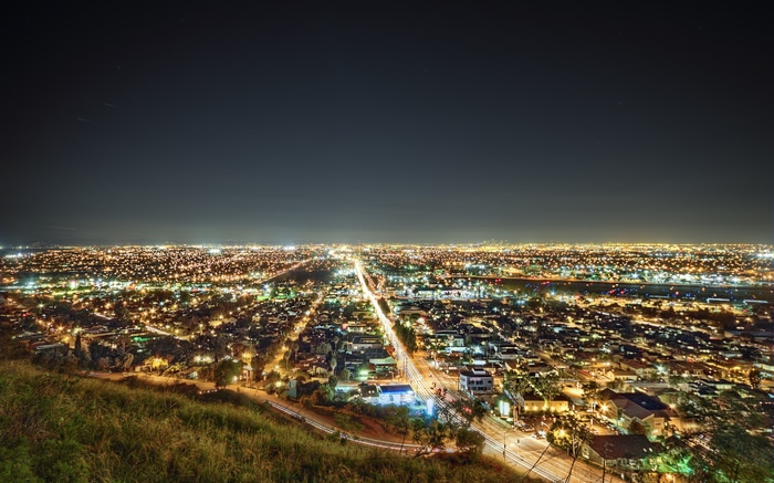 Nighttime cityscape of Los Angeles with glowing lights