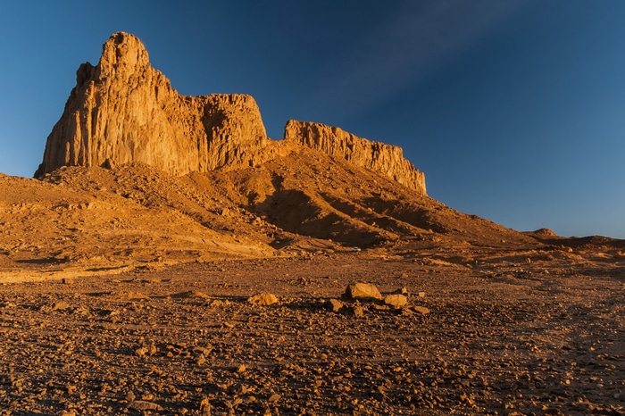 Desert landscape with rock formations and clear blue sky
