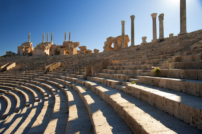 Ancient Roman amphitheater ruins in Libya under a clear blue sky