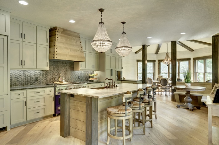 Kitchen with island, chandeliers, and dining area