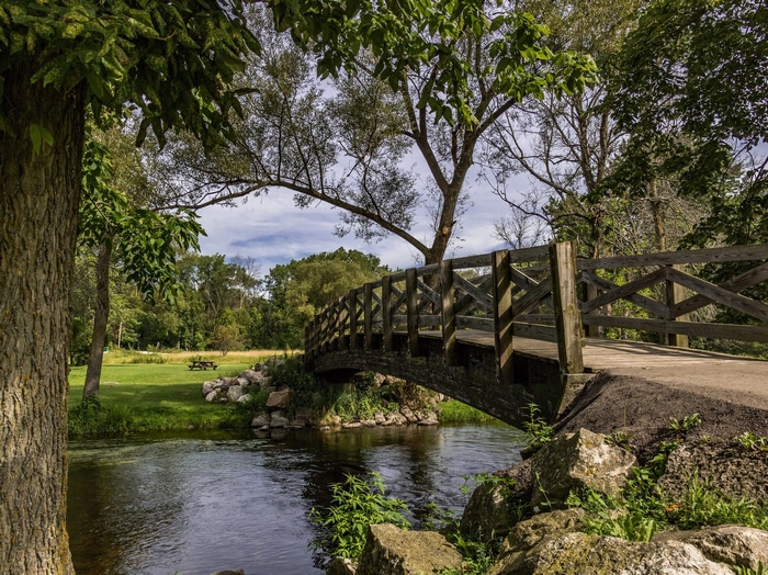 Wooden bridge over a stream in a park in Wisconsin