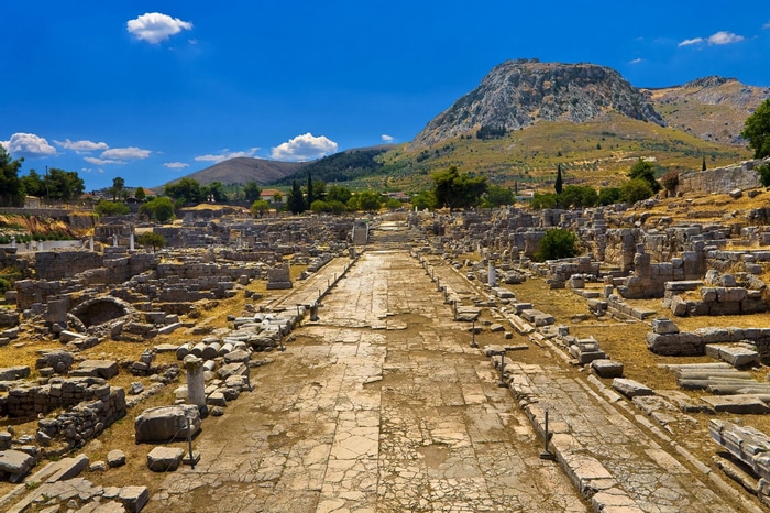 Ancient ruins of Corinth under a blue sky