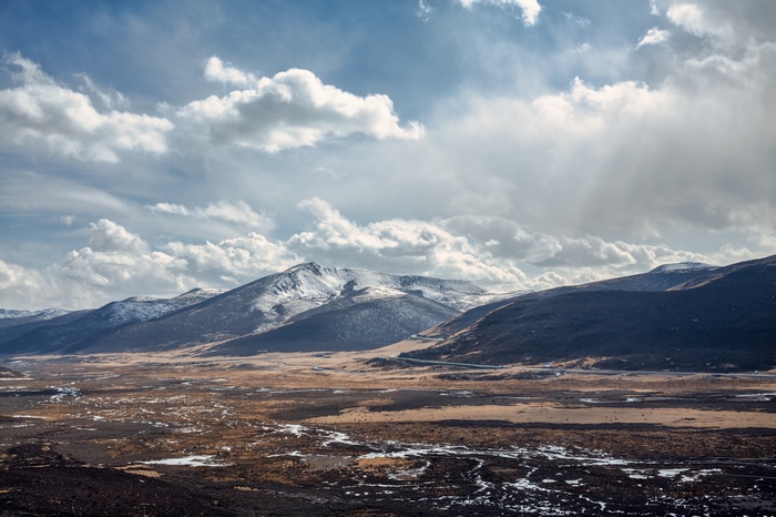 4K Snowy Mountains Under Cloudy Sky