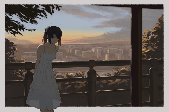 Girl in a white dress on a balcony at sunset