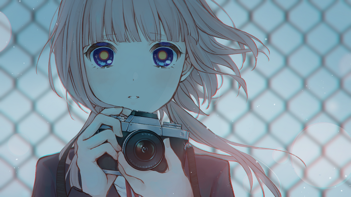 Girl with camera in front of a fence