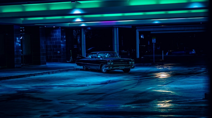 4K old car in a parking lot at night