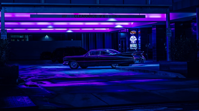 1960 Cadillac Deville parked under purple lights