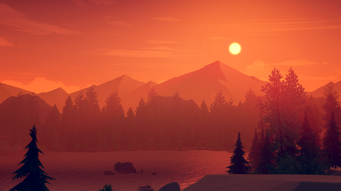 Sunset over mountains and lake with pine trees