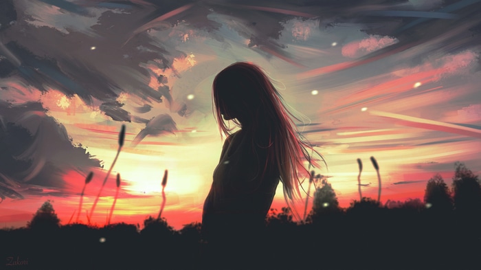 Silhouette of a woman against a sunset sky