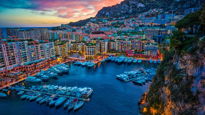 4K Monaco cityscape with yachts in harbor at sunset