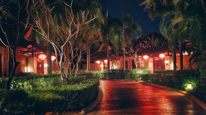 4K night view of a tropical resort entrance with lanterns